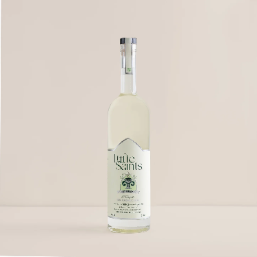 Bottle of Little Saints gin on a beige background