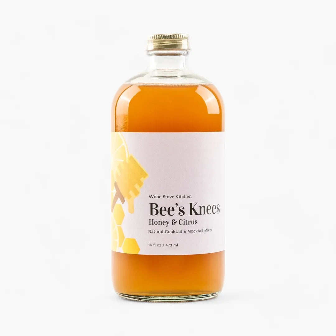 Bottle of 'Bee's Knees Honey & Citrus' cocktail mixer on a white background