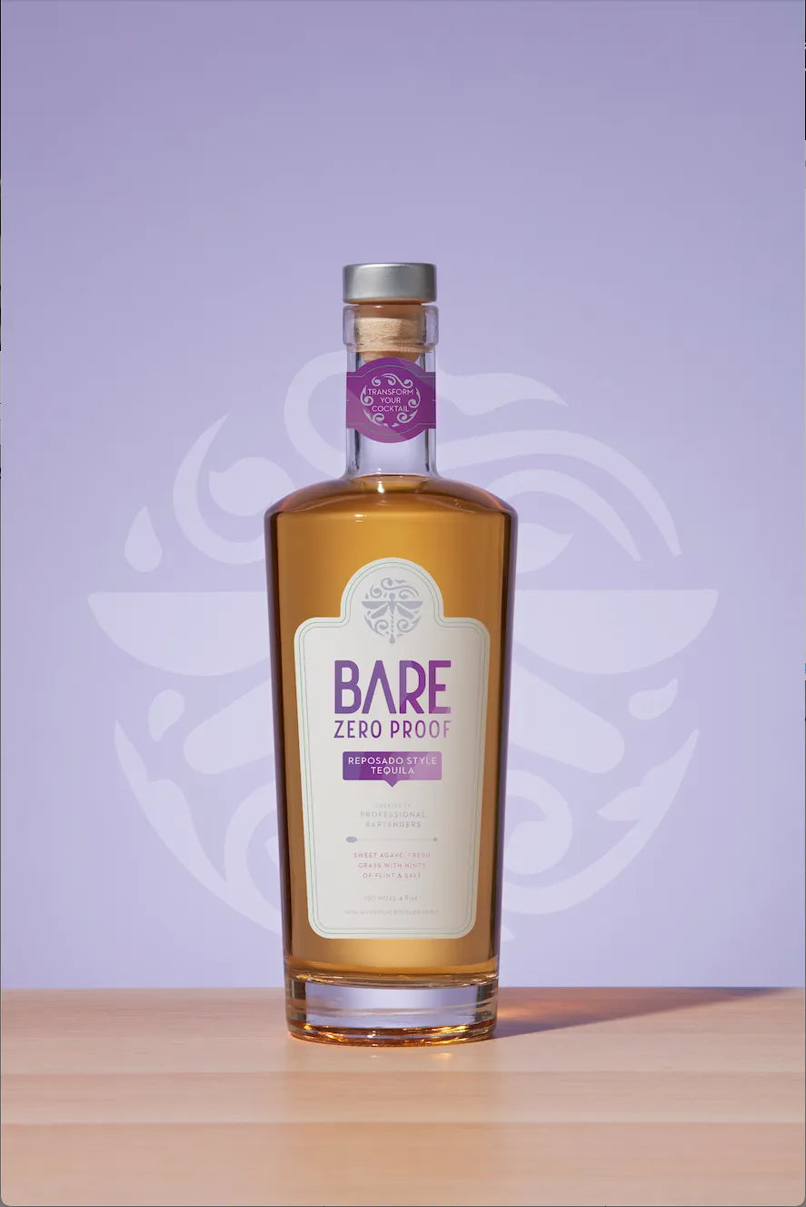 Bottle of Bare Zero Proof on a wooden surface with a purple background