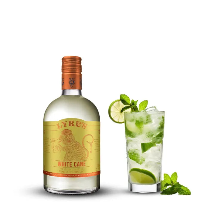 Lyre's White Cane bottle with a mojito cocktail on a white background