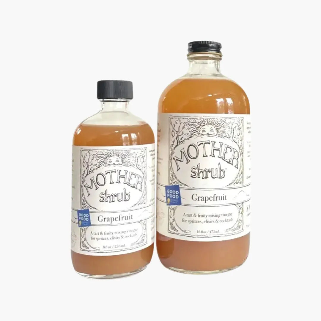 Two bottles of Mother Shrub grapefruit shrub on a white background