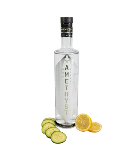 Amethyst bottle with sliced cucumbers and lemons on a white background