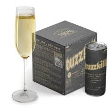 Bottle of Buzzkill sparkling water with a glass of champagne and packaging in the background.