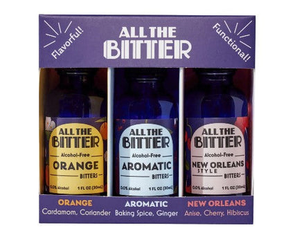 Three bottles of 'All The Bitter' bitters with labels for Orange, Aromatic, and New Orleans styles on a purple background.