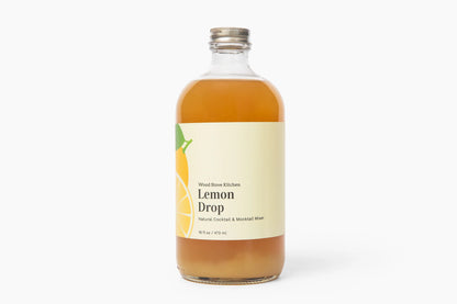 Bottle of Lemon Drop syrup with a label on a white background