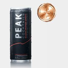 Peak cocktails energy drink can with a gold coin on a white background