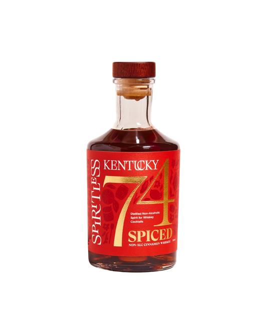 A bottle of Kentucky 74 Spiced Non-Alcoholic Whiskey, featuring a red label with gold lettering and a red screw cap, set against a plain white background.
