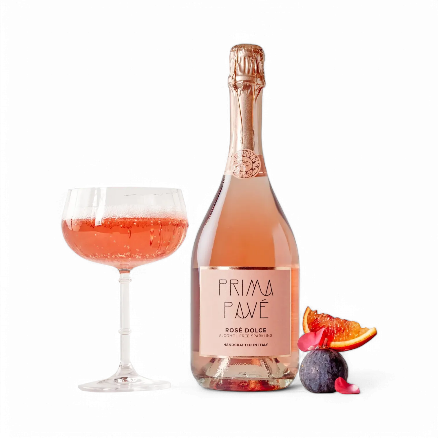 Bottle of Prima Pave Rose Dolce with a glass of pink wine and fruit on a white background