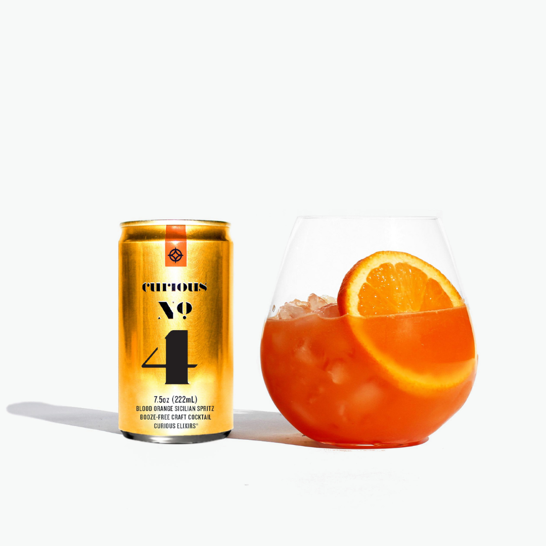 Curious No 4 can next to a cocktail with an orange slice on a white background