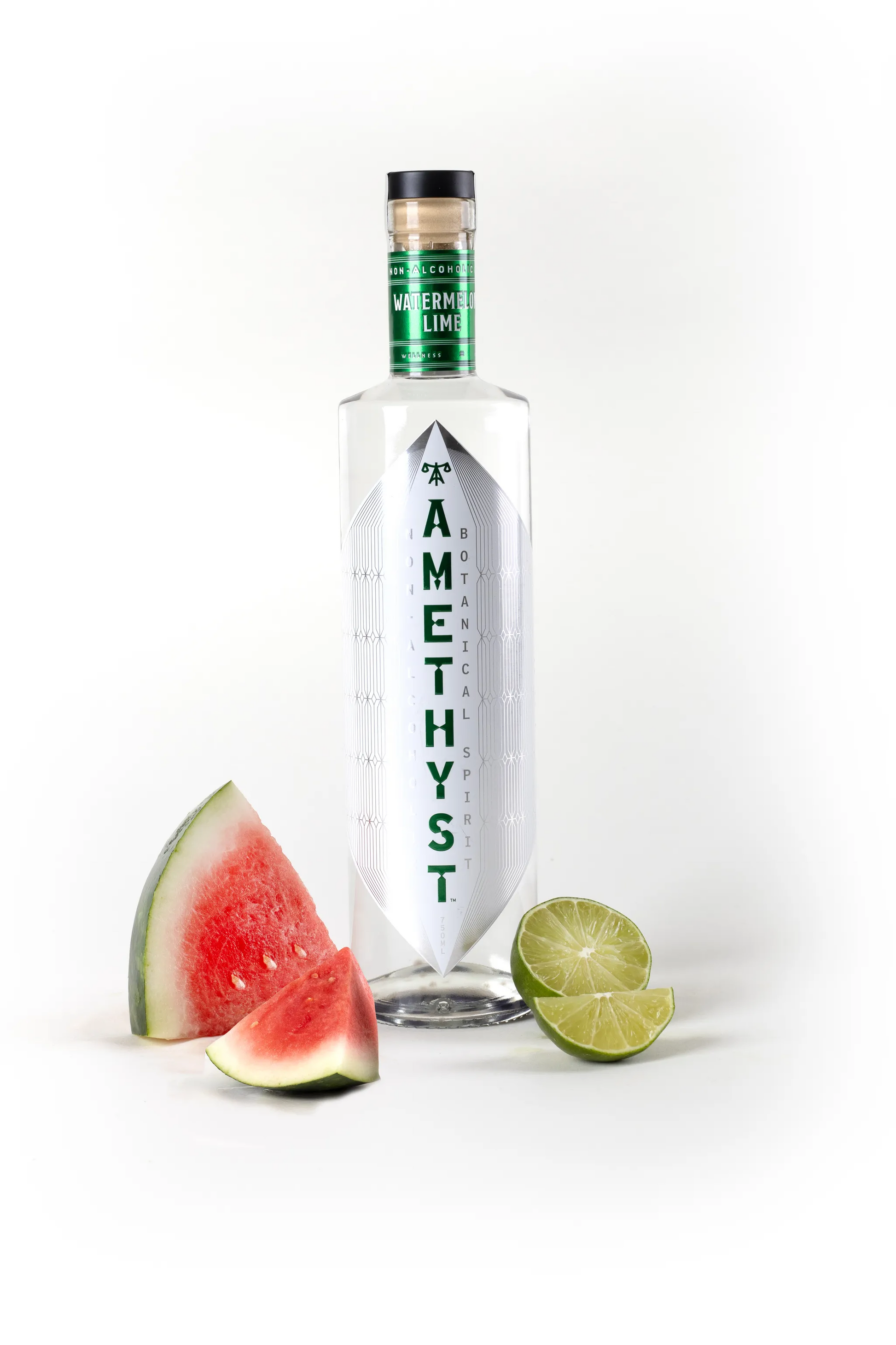 Bottle of 'Amethyst' gin with a slice of watermelon and lime on a white background