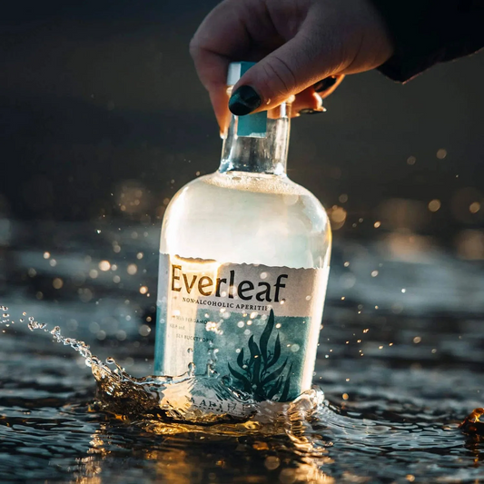Bottle of Everleaf non-alcoholic appletini being submerged in water