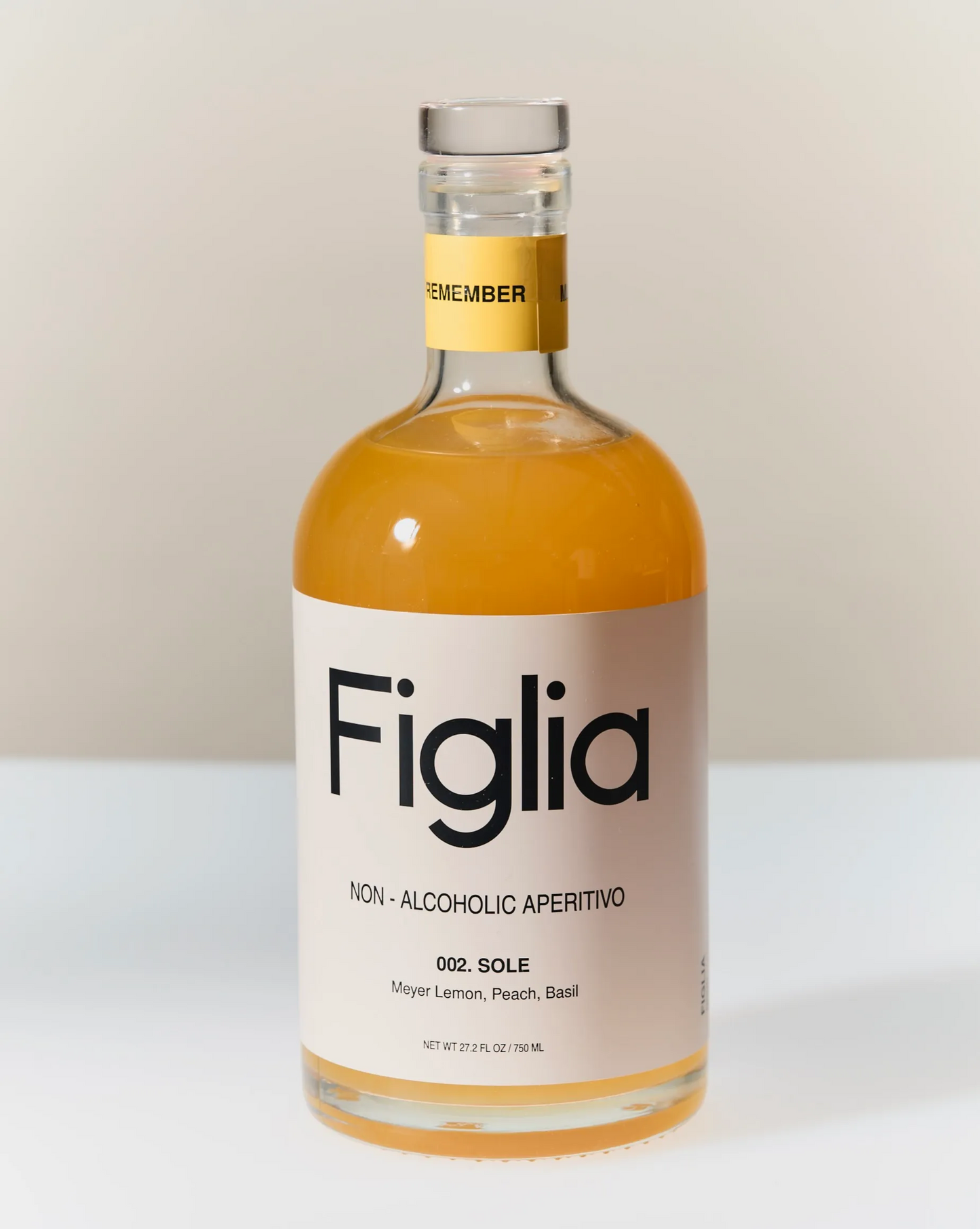 Bottle of Figlia non-alcoholic aperitivo on a white surface with a neutral background