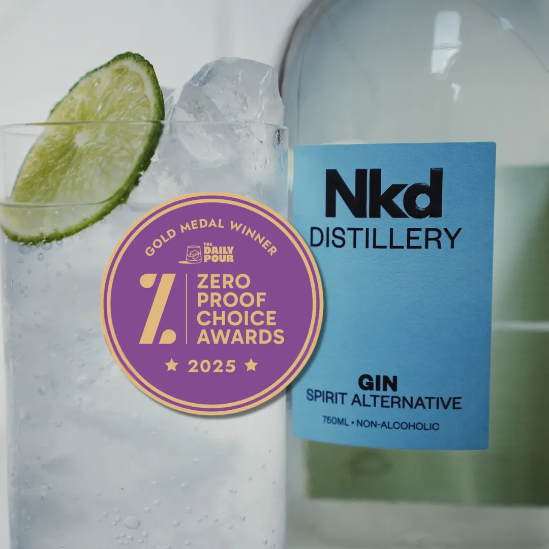 Bottle of Nkd Distillery gin with a glass of ice and lime, featuring a 2025 award badge.