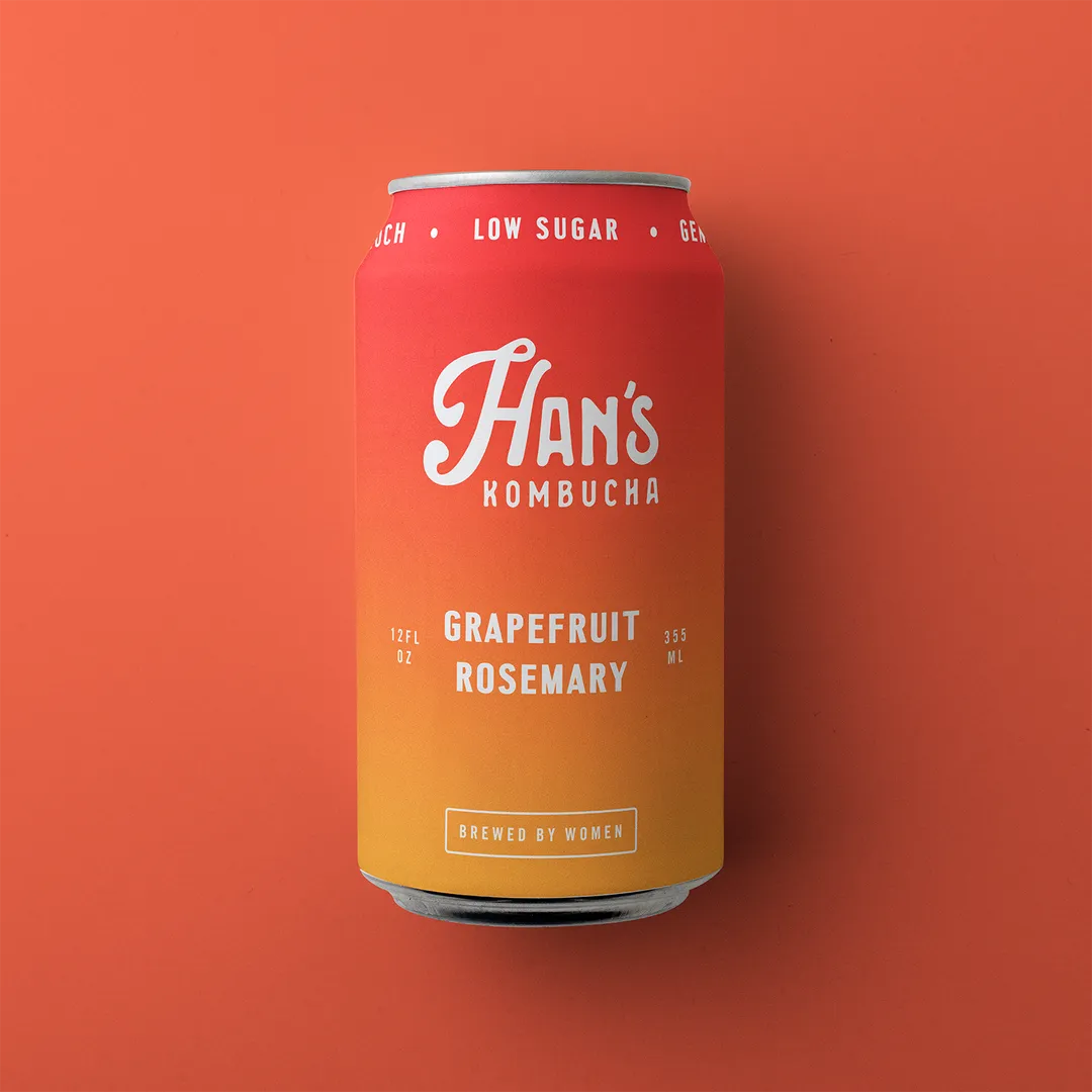 Red can of Han's Kombucha with grapefruit and rosemary flavor on an orange background