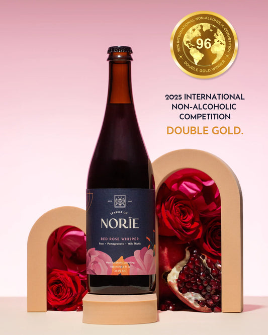 Bottle of Norie wine with decorative arches and roses on a pink background