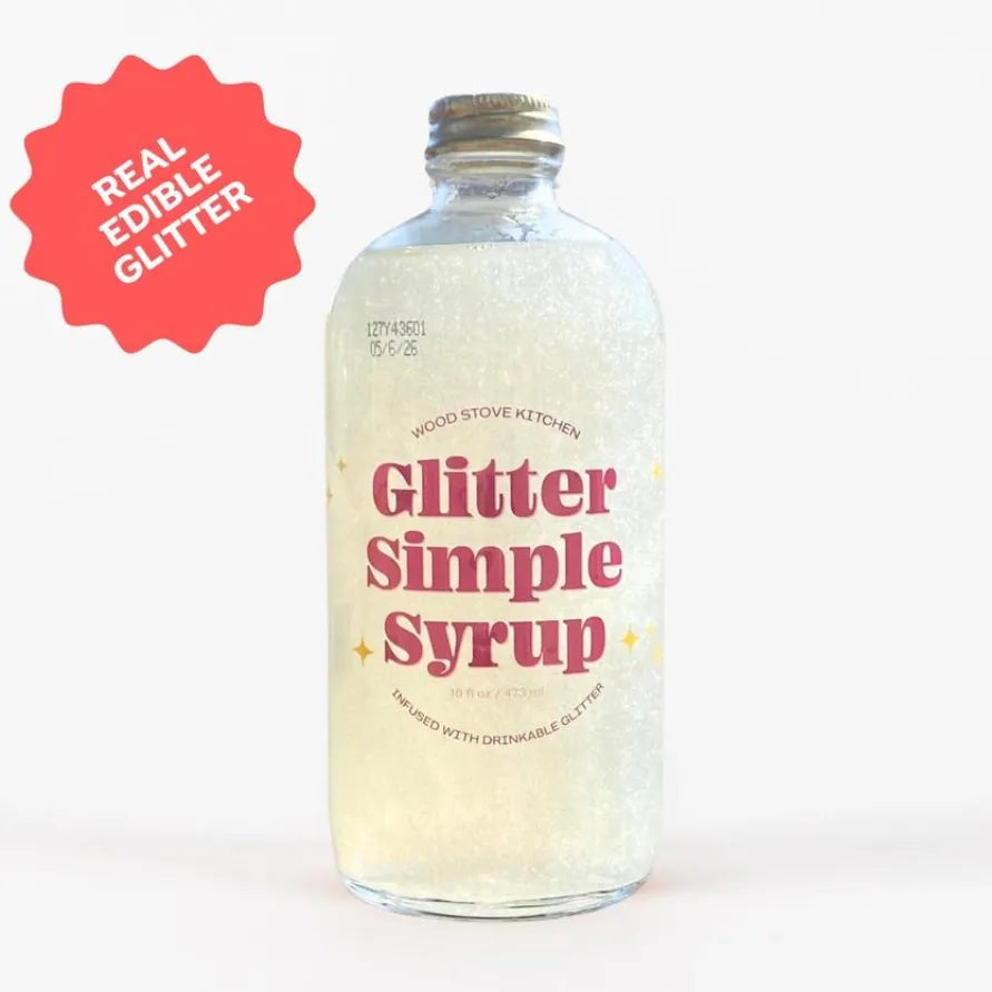 Bottle of 'Glitter Simple Syrup' with a label and red starburst indicating 'Real Edible Glitter'.