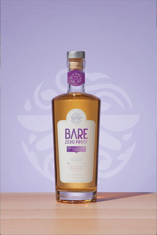 Bottle of Bare Zero Proof on a wooden surface with a purple background