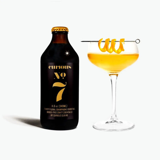 Curious bottle and cocktail with orange liquid on a white background