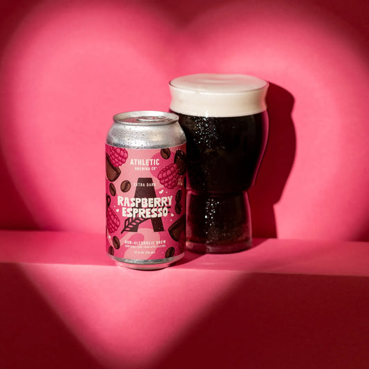 Cans and glass of Raspberry Espresso NA beer on a pink background