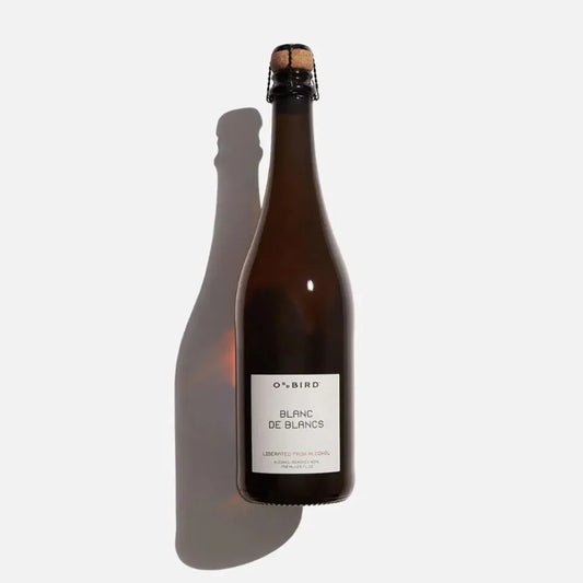 Bottle of Oddbird Blanc de Blancs wine on a white background