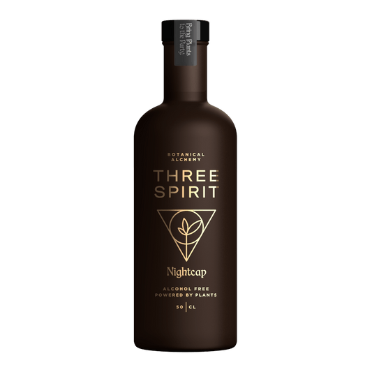 Bottle of Three Spirit Nightcap on a green background
