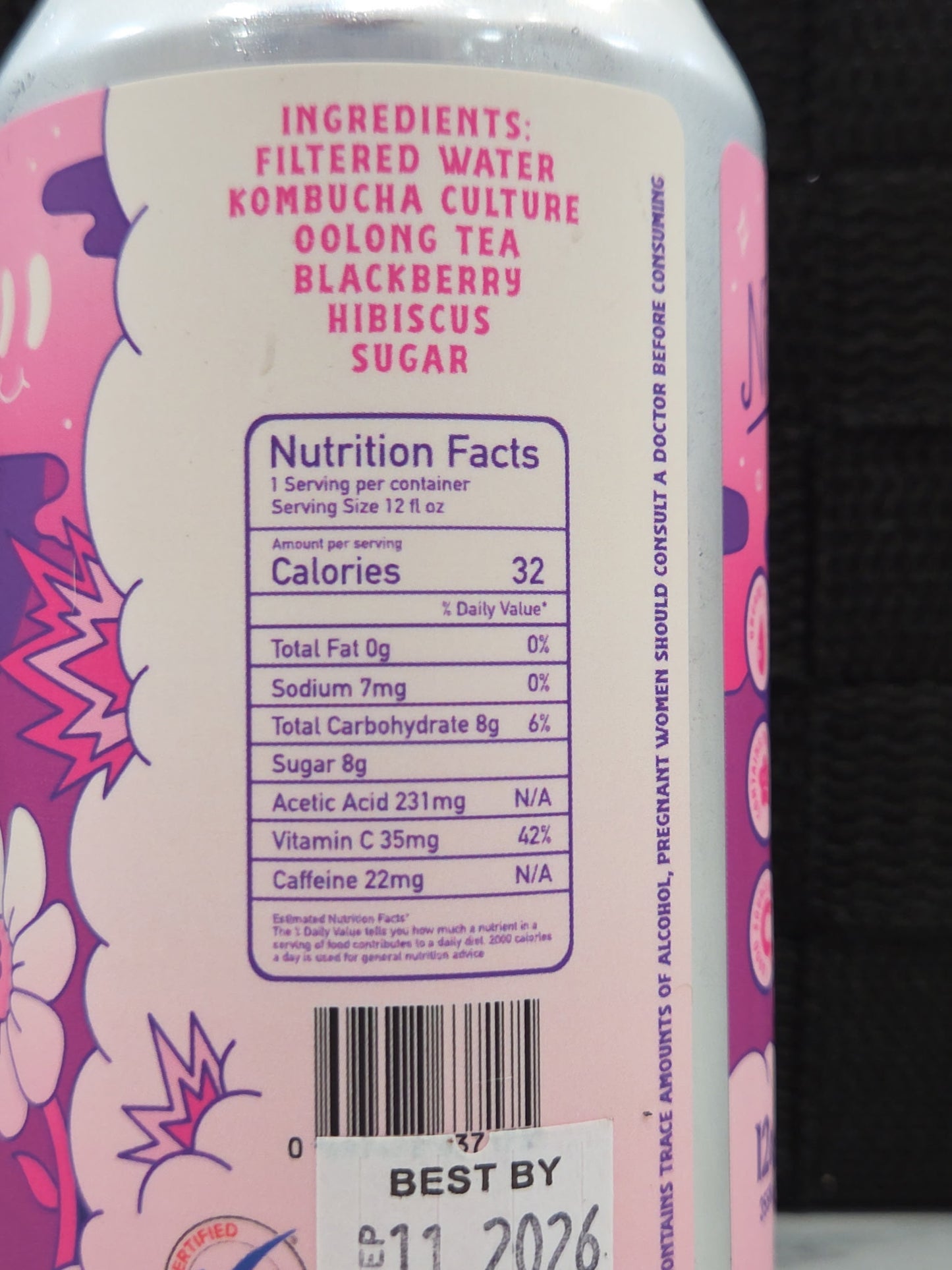 Back label of a pink bottle with nutritional information and ingredients on a dark background
