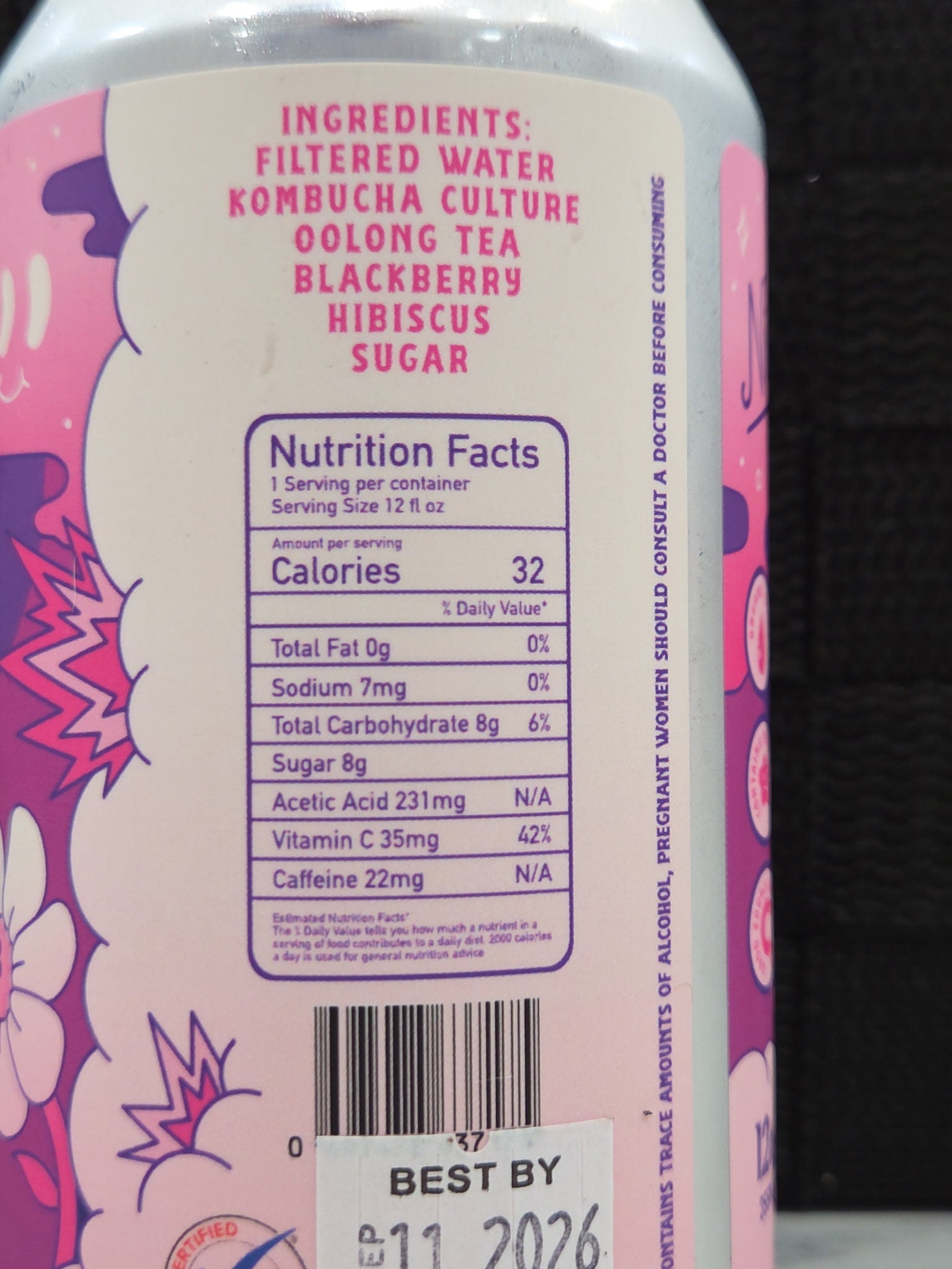 Back label of a pink bottle with nutritional information and ingredients on a dark background