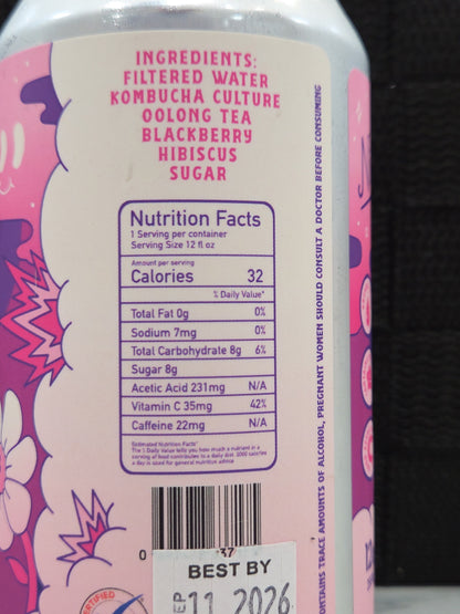 Back label of a pink bottle with nutritional information and ingredients on a dark background