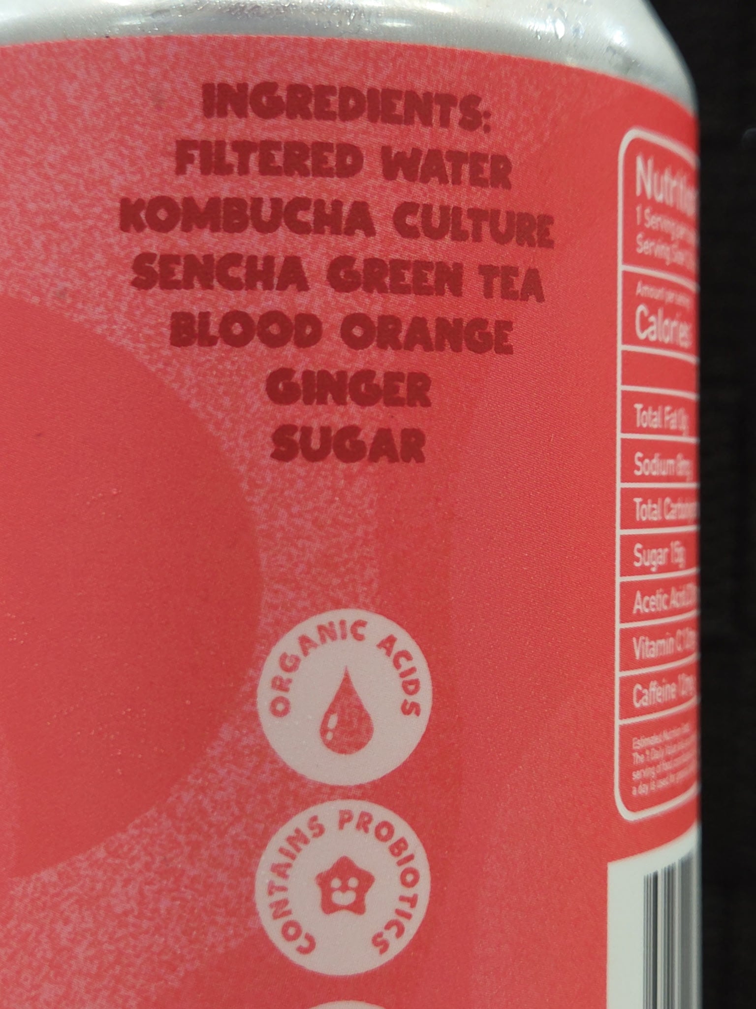 Back label of a drink container with ingredients listed on a red background