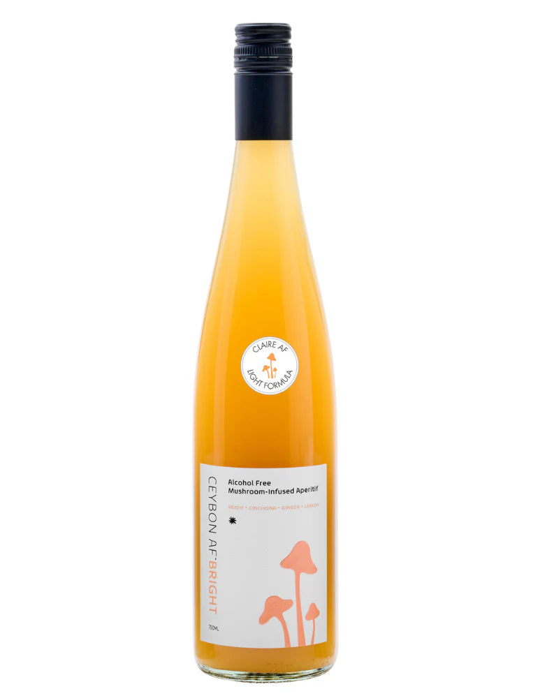 Bottle of alcohol-free lemon mushroom liqueur on a white background