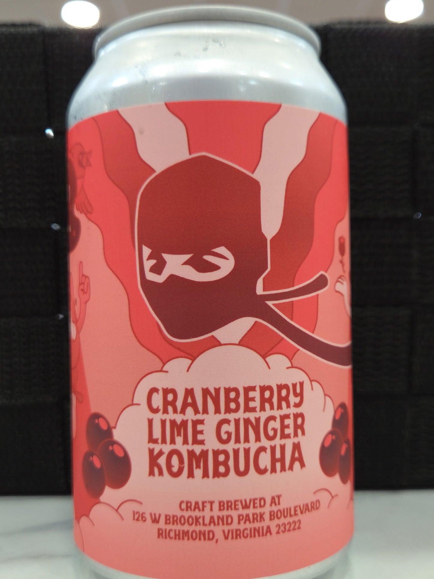Cranberry Lime Ginger Kombucha can with a red design on a white background