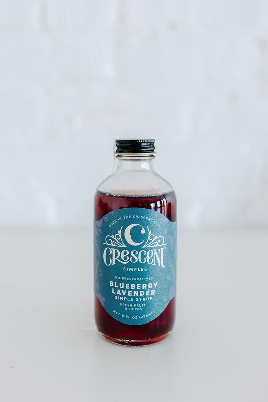 Bottle of Crescent Blueberry Lavender syrup on a white background