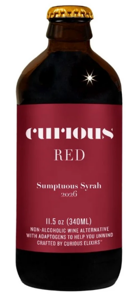 A bottle of Curious Red Sumptuous Syrah 2026, featuring a dark brown glass bottle with a gold cap and a deep red label with white text.
