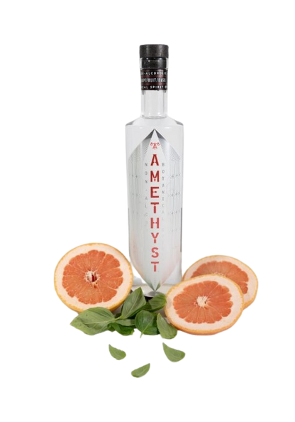 Bottle of Tamethyst with grapefruit slices and leaves on a white background